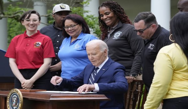 President Joe Biden sign a document in the Rose Garden of the White House on Tuesday, imposing major new tariffs on supplies from China